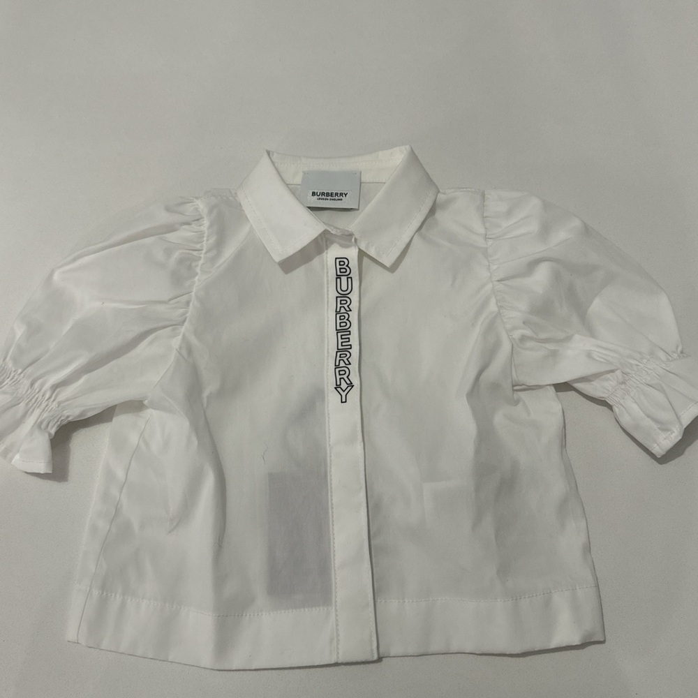 Burberry button up shirt with slightly puffy sleeves in white. Size 12months